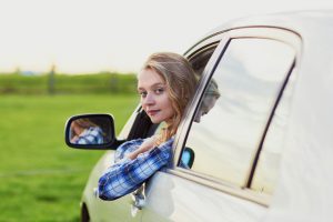 young driver looking out of the car window